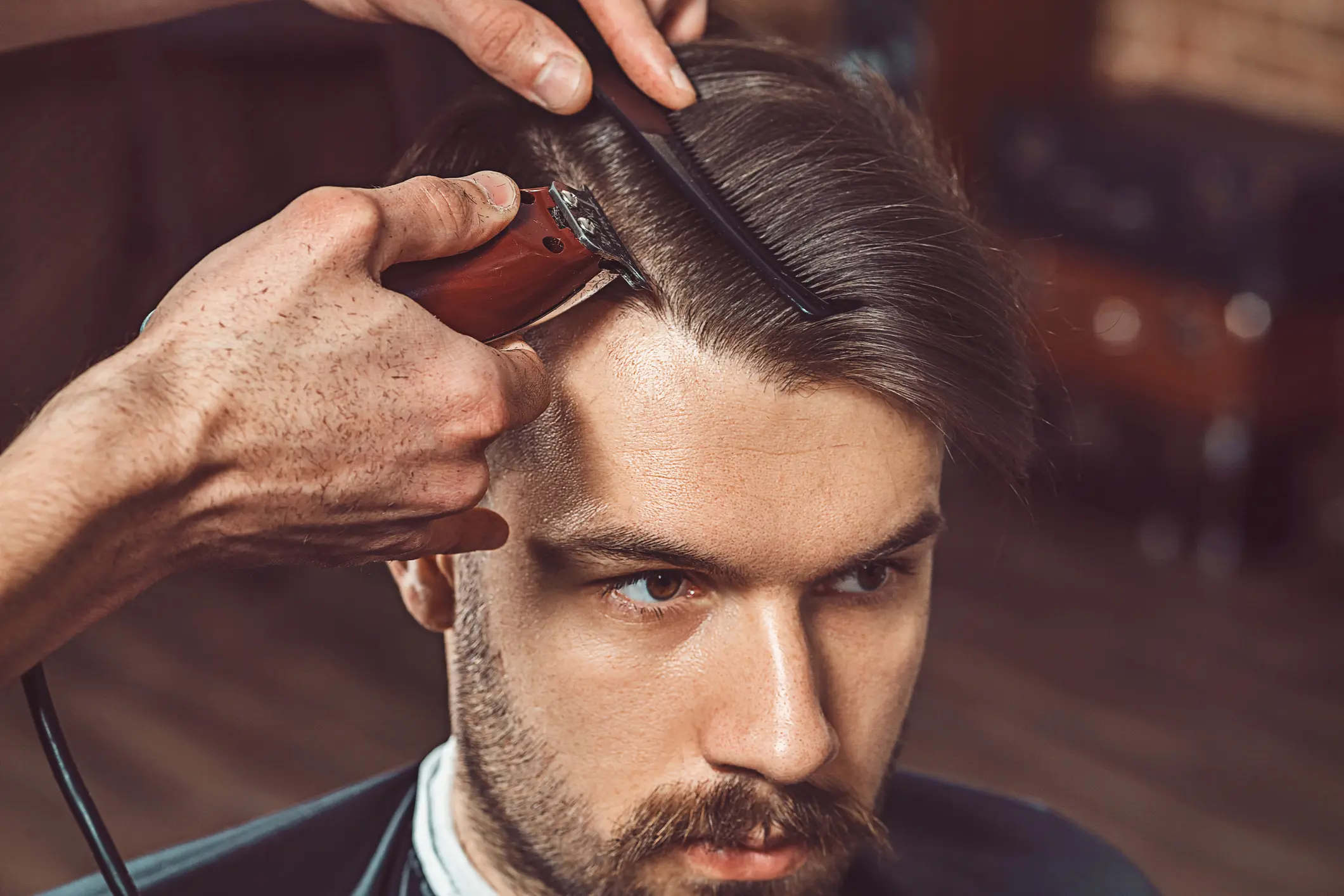 Man getting a haircut with clippers.